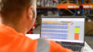 Mitarbeiter prüft den Lagerbestand vor dem Bildschirm Mitarbeiter prüft den Lagerbestand vor dem Bildschirm